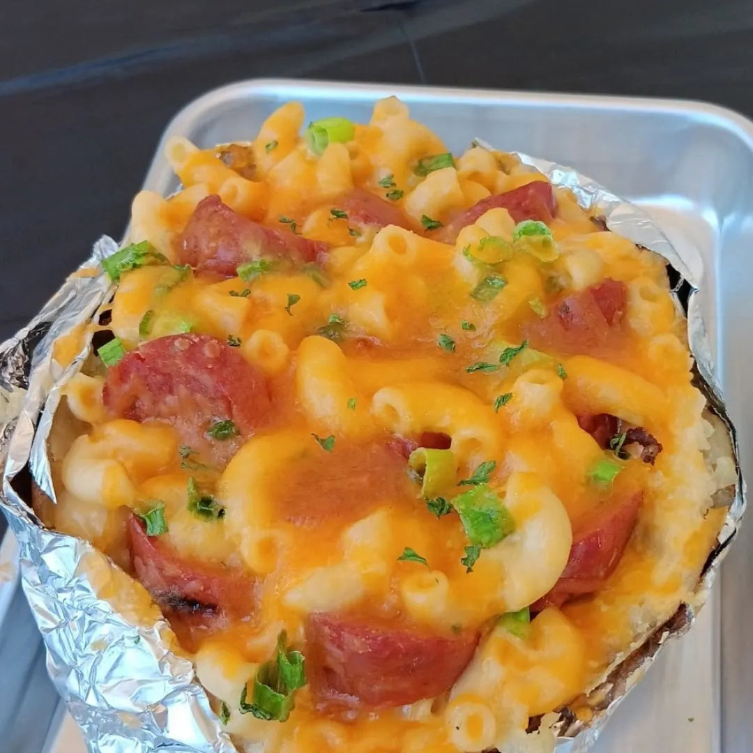 Baked potato loaded with mac and cheese and jalapeño cheddar sausage available for online pickup and delivery from Hoodidya BBQ in Redlands, California