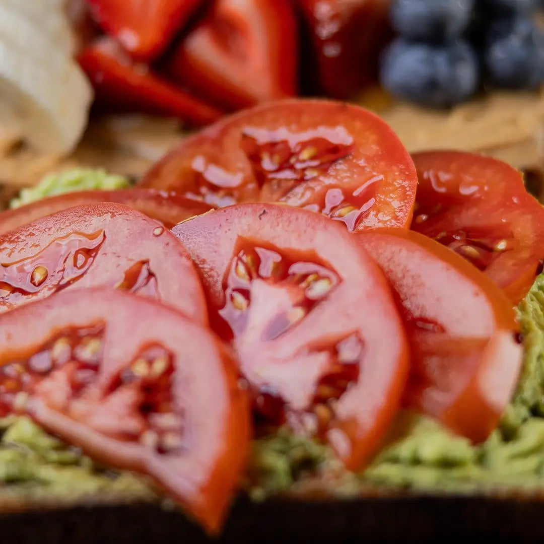 Avocado toast topped with fresh tomatoes available for online pickup and delivery from Fresh Juiced Juice Bar in Redlands, California

