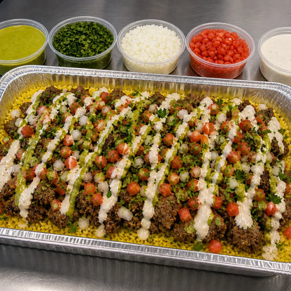 Beef gyro catering tray over rice with sauces and toppings available for online pickup and delivery from Redlands Ranch Market in Redlands, California
