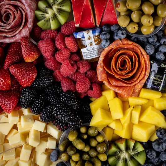 Fresh charcuterie board with meats, cheeses, fruit, and crackers available for online pickup and delivery from Fresh Juiced Juice Bar in Redlands, California
