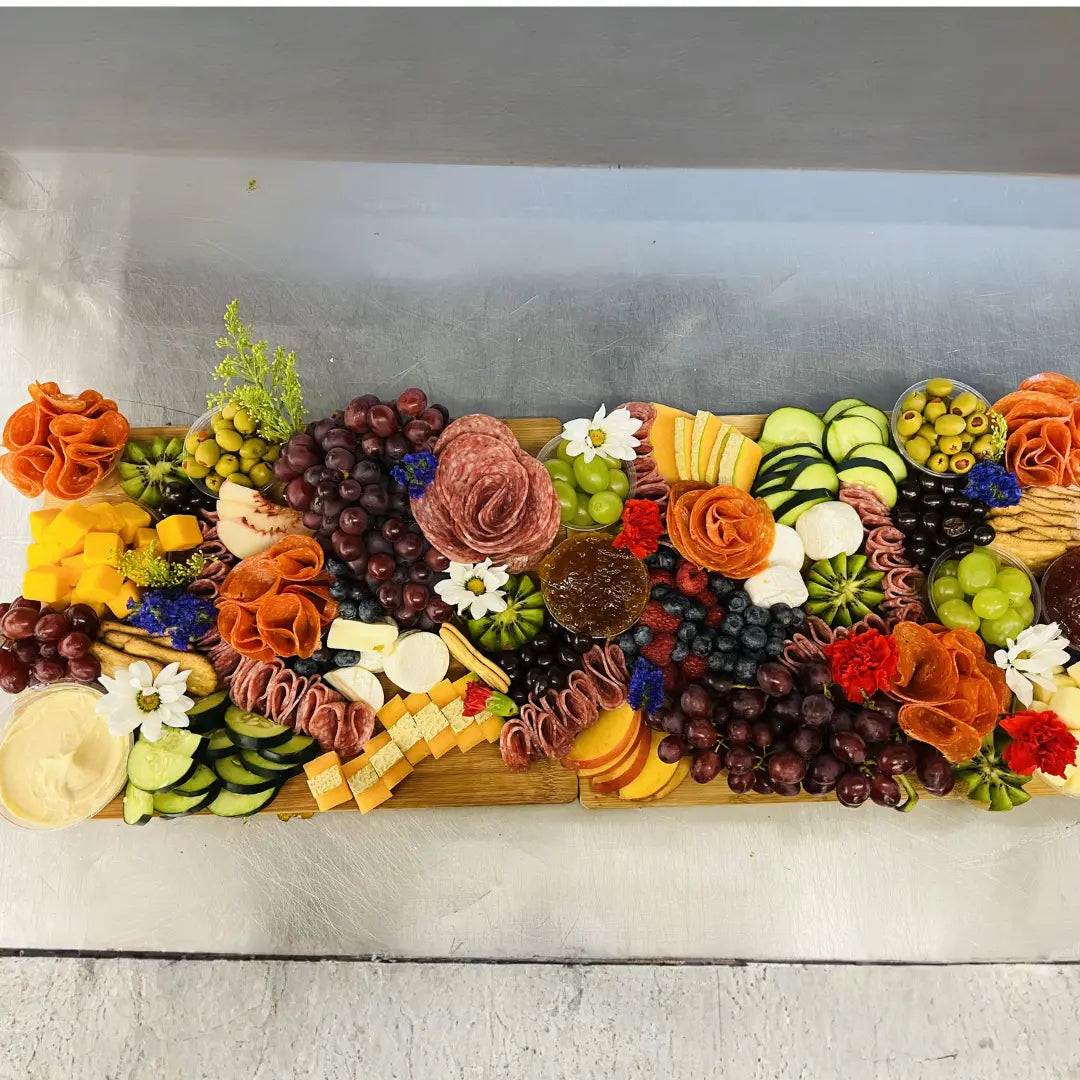 Party charcuterie board with fresh fruit, cheeses, meats, and crackers available for online pickup and delivery from Fresh Juiced Juice Bar in Redlands, California