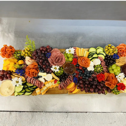 Party charcuterie board with fresh fruit, cheeses, meats, and crackers available for online pickup and delivery from Fresh Juiced Juice Bar in Redlands, California