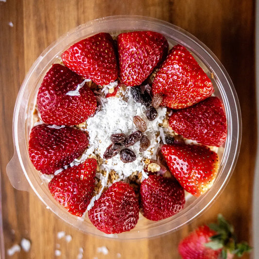 Strawberry bionico bowl topped with coconut and raisins available for online pickup and delivery from Fresh Juiced Juice Bar in Redlands, California