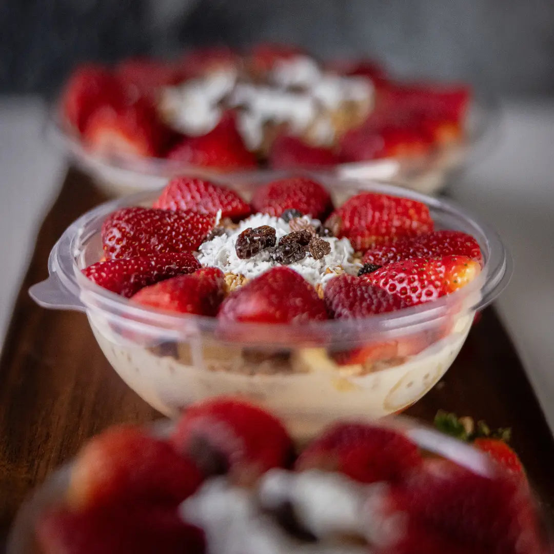 Fresh strawberry bionico bowl with sweet cream, coconut, and granola available for online pickup and delivery from Fresh Juiced Juice Bar in Redlands, California
