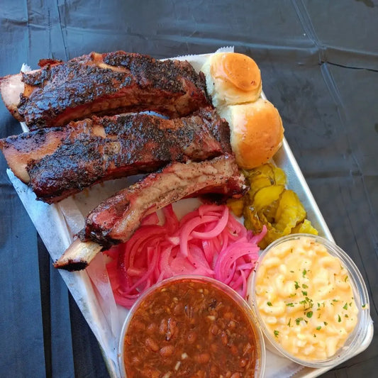 Fireside BBQ meal with smoked meats, sides, and rolls available for online pickup and delivery from Hoodidya BBQ in Redlands, California