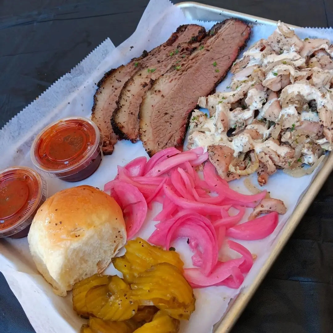 Two meat BBQ plate with sliced brisket, sides, and pickled onions available for online pickup and delivery from Hoodidya BBQ in Redlands, California.