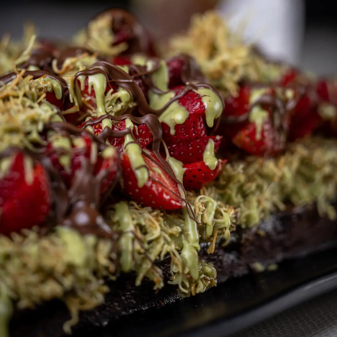 Strawberry Dubai brownie topped with pistachio cream and chocolate available for online pickup and delivery from Fresh Juiced Juice Bar in Redlands, California
