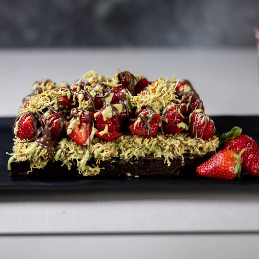 Gooey strawberry Dubai brownie with pistachio topping available for online pickup and delivery from Fresh Juiced Juice Bar in Redlands, California

