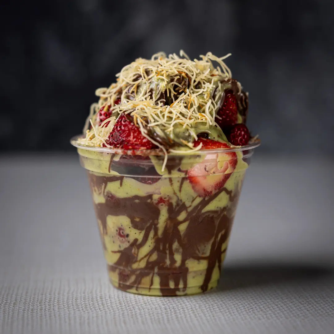 Fresh strawberry Dubai dessert cup topped with pistachio and chocolate available for online pickup and delivery from Fresh Juiced Juice Bar in Redlands, California

